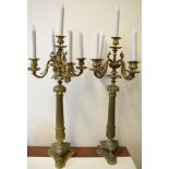 A pair of gilt four branch candelabra, with Corinthian style columns on triform bases,