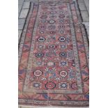 A Persian carpet, decorated floral motifs on a pink ground, within a multi border,
