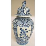 A large Delft vase and cover, decorated flowers and foliage in underglaze blue,