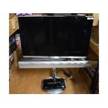 A B & O television, 88 cm wide, on a stand, with a sound bar,