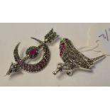 A silver, marcasite and ruby brooch/pendant, in the form of a robin, and another,