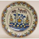 A Dutch polychrome plate, with floral decoration, some fritting, 30.