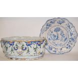 A tin glazed jardiniere, of shaped oval form, decorated flowers and foliage, cracked, 40 cm wide,