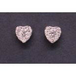 A pair of 9ct white gold and diamond heart shape stud earrings