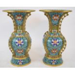 A pair of cloisonné vases, decorated flowers on a turquoise ground, 26.