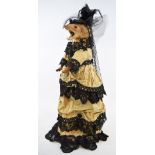 Taxidermy: an anthropomorphic mounted ferret, dressed in Victorian style lady's clothing,