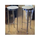 A pair of wrought iron circular stools,