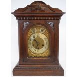A mantel clock, the gilt arched dial with silver chapter ring and Arabic numerals,