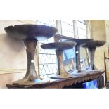 A set of four African tribal carved wood circular occasional tables, possibly Nagaland,