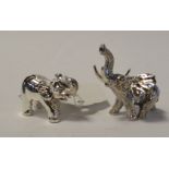 A miniature silver elephant, and another similar, the largest 3.