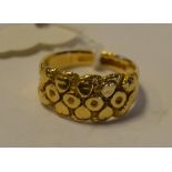 An 18ct gold ring, with raised decoration, approx. ring size Q, approx. 7.