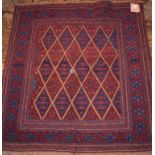 A tribal rug, geometric motifs on a red ground,
