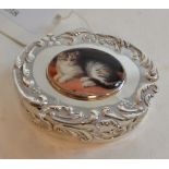 An oval silver box, applied a cat plaque,
