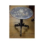 A Victorian papier-mâché tripod table, decorated dwellings and figures,