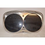 A plated double picture frame, in the form of a Rolls Royce headlight unit,