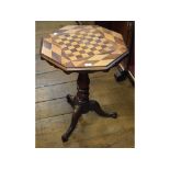 A Victorian tripod table, the octagonal top inlaid with birdseye maple and rosewood for chess,