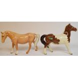 A Beswick Boy's Pony, palomino, 1480, ears restored, and a Girl's Pony, skewbald, 1483,