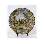 A large Italian maiolica charger, the centre decorated a maiden and a donkey by a well,