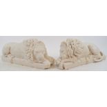 A pair of composition recumbent lions,