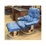 An Ekornes leather upholstered armchair and ottoman,