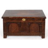 A late 17th/early 18th century inlaid oak coffer, of small proportions, on stile legs,
