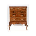 A walnut chest on stand, with feather crossbanding,