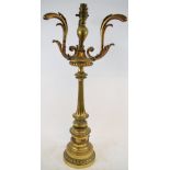 A brass table lamp, the base decorated ribbon ties and swags, 56.