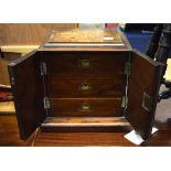 A late Victorian inlaid walnut table top chest, and a pair of doors enclosing three drawers,