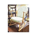 An Ercol beech and elm rocking chair, another similar,