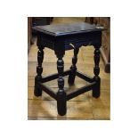 A late 17th/early 18th century walnut and oak stool, on turned legs, 47.