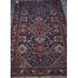 A Persian rug, with a central medallion on a blue ground, within a multi border,