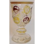 A Bohemian ruby and amber cut and flashed glass goblet, with a gilt rim,