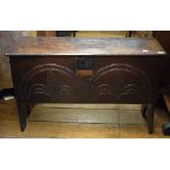 A small 17th century carved oak six plank coffer,