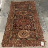 A Persian rug, decorated geometric motifs on a cream ground, within a multi border, 200 x 110 cm,