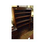An Edwardian oak open bookcase, with fluted columns,