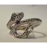 A silver bangle, in the form of a snake,