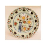 A Dutch polychrome plate, with floral decoration, some fritting, 34.