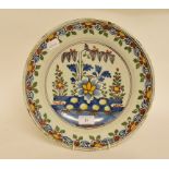 A Dutch polychrome plate, with floral decoration, some fritting, 30.