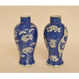 A pair of Chinese porcelain blue and white vases, both repaired, 19 cm high,