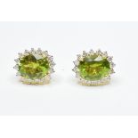 A pair of large peridot and diamond clus