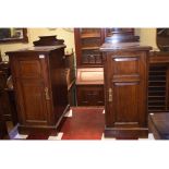 A pair of walnut bedside cupboards, each