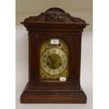 A mantel clock, the gilt arched dial wit