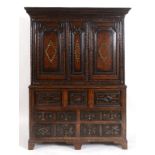 A 19th century inlaid oak cupboard on ch