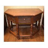 A carved oak credence style table, on ba