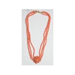 A three strand coral necklace, with a ce