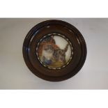 A circular miniature picture, of kittens