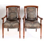 A pair of walnut upholstered armchairs,