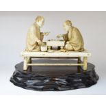 A Japanese carved ivory group, in the fo