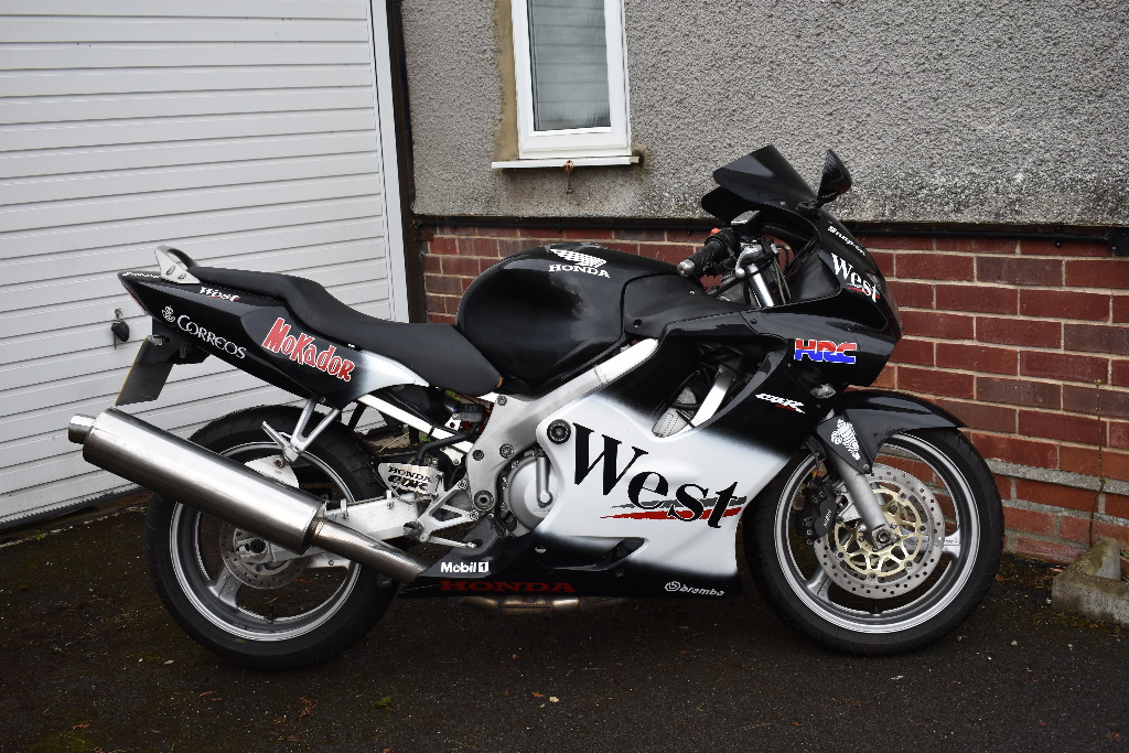 A 2000 Honda CBR600F, registration number W357 TDV, West racing colours.