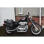 A 1999 Harley-Davidson Sportster 883, registration number T504 JGT, black.